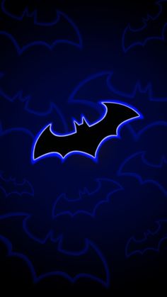 the bat symbol is lit up on a dark background with blue bats in the sky