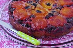 a cake on a glass plate with a knife and fork in front of the cake