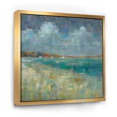 an abstract painting with blue, green and yellow colors on the wall above it is a gold frame