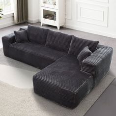 a large black couch sitting on top of a rug