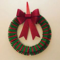 a christmas wreath made out of toothpicks with a red bow