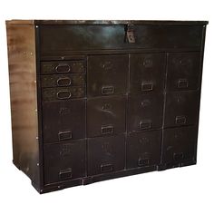 a large metal filing cabinet with many drawers on it's front and side doors