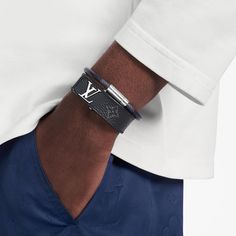 Slim and sleek, with an inlaid lv clasp that lies flush to the strap, this new masculine bracelet is offered in black calfskin, monogram or monogram eclipse coated canvas. All are calf-leather lined. Easy to wear, this signature piece makes a handsome little gift. Lv Men Bracelet, Lv Slim Bracelet, Lv Bracelet For Men, Luxury Adjustable Leather Bracelet, Luxury Black Leather Bracelet With Palladium Hardware, Luxury Black Bracelets, Designer Black Leather Bracelet, Luxury Leather Bracelet, Louis Vuitton Birthday