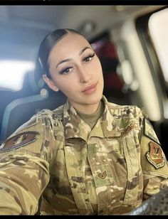 a woman in uniform is sitting down