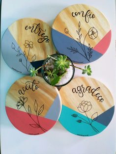 four wooden coasters with plants on them