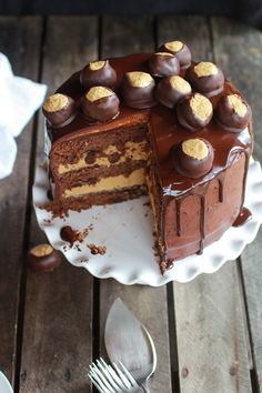 a chocolate cake on a plate with one slice cut out