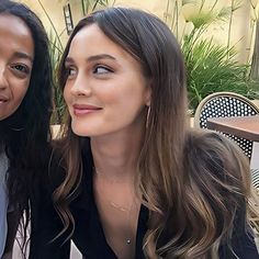 two women sitting next to each other at a table