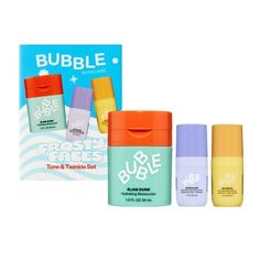 three bottles of bubble paste next to a box