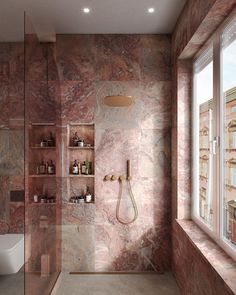 a bathroom with marble walls and flooring next to a window