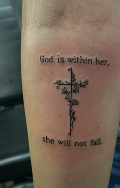 a cross with the words god is within her, she will not fall