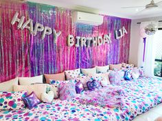 a bedroom decorated in pink, purple and blue