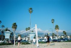 some people are playing volleyball on the beach