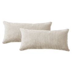 two white pillows sitting next to each other