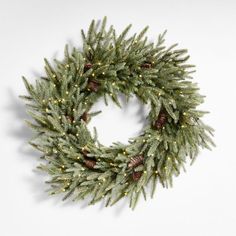 a christmas wreath with pine cones and lights