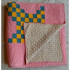 This is a wonderful early 20th-century meticulously hand-stitched summer-weight New England quilt in brightly colored yellow and blue squares on a red calico ground, and it also has a small geometric pattern on the back. The quilt pattern is a Triple Irish Chain. It has a great feel and can be used on a bed, displayed on a wall, or draped over furniture. It's nice on both sides.  Deirdre’s Bio: This comes from the archives of Deirdre Coughlin, founder of Phoebe’s Closet. She specializes in antiq Crossed Canoes Quilt, Quilt Squares Patterns, Yellow Brick Road Quilt, Triple Irish Chain, Quilt Tapestry, Scandinavian Quilts, Small Geometric Pattern, Quilt Board, Hand Stitched Quilt