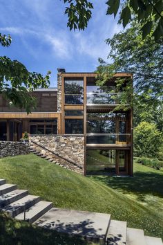 an exterior view of a modern house with stone steps