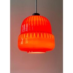 an orange and red light hanging from a ceiling