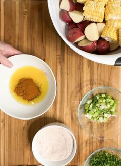 an overhead view of ingredients for corn on the cob with potatoes and carrots