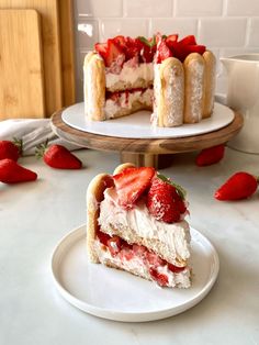 there is a piece of cake with strawberries on the top and one slice missing