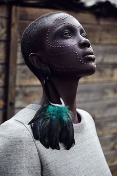 an african woman with feathers on her neck