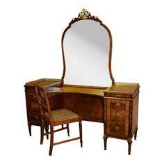 an antique dressing table with mirror and stool