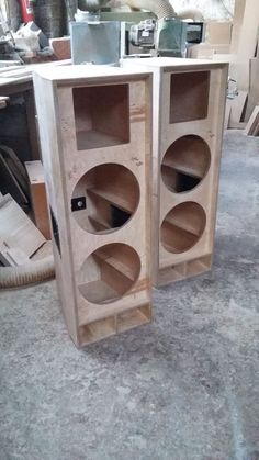 two wooden shelves sitting next to each other on top of a floor in a room