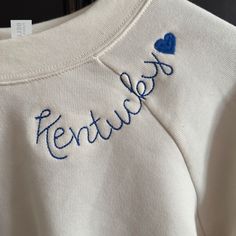 Bella Canvas Embroidered Sweatshirt! Show Your Kentucky Spirit With This Cute Vintage White Embroidered Sweatshirt "Kentucky" With A Heart! -Supersoft Pullover Sweatshirt With Ribbed Cuffs -Relaxed Fit -Falls Right At The Hip -52% Airlume Cotton, 48% Polyester Fleece -Small Fits 30-32" Chest, Medium Fits 32-34" Chest, Large Fits 36-38" Chest Embroidery Sweatshirt Designs, College Embroidered Sweatshirts, Machine Embroidered Gifts, Reverse Applique Sweatshirt, Diy Embroidery Letters, Embroidered College Sweatshirt, Lake Sweatshirt, Stitched Sweatshirt, Sweater Diy