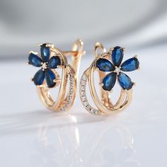 Do you want to show everyone that you're a luxuriously fashionable woman? These Blue Zircon Floral Earrings are exquisitely beautiful earrings that will impress everyone. The blue flower design is a unique style that makes these earrings look very expensive. Buy these for anniversaries, birthdays, holidays, or just because. Specifications: Side Stone: Natural White Zircon Main Stone: Blue Zircon Size: 17mm * 14 mm Metal: 585 (14kt) Gold Vermeil 🚐Delivery: 2-3 weeks Elegant Blue Hoop Earrings For Formal Occasions, Blue Flower Shaped Earrings For Formal Occasions, Elegant Flower-shaped Hoop Earrings For Anniversary, Elegant Flower Hoop Earrings For Anniversary, Blue Flower-shaped Formal Earrings, Formal Blue Flower-shaped Earrings, Blue Formal Flower-shaped Earrings, Blue Elegant Design Earrings For Anniversary, Elegant Blue Hoop Earrings