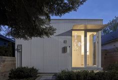 the front door is open to let in light on the house's exterior facade