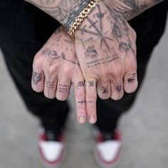 a man with many tattoos on his hands