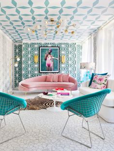 a living room with blue and pink furniture in it's centerpiece, while the walls have geometric designs on them