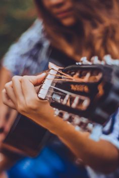 a person holding a guitar in their hands