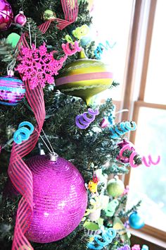 a christmas tree decorated with ornaments and ribbons