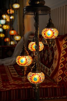 a chandelier with five lights hanging from it's sides on a red rug