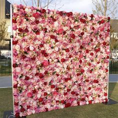 a large flowered wall in the middle of a park