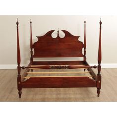 an antique wooden bed frame with four posts