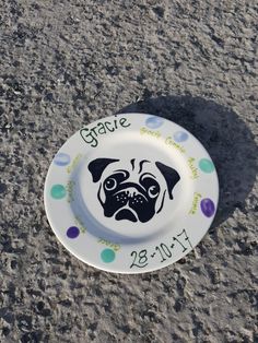 a plate with a dog on it that says grace and is decorated with polka dots