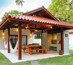 an outdoor covered patio with hammock chairs