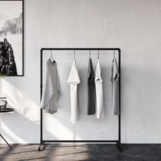 an iron rack with clothes hanging on it