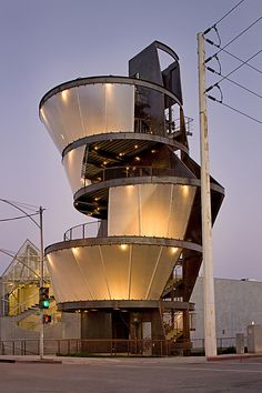 a very tall building sitting on the side of a road next to a traffic light