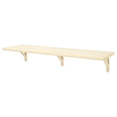 a wooden shelf sitting on top of a white wall