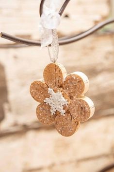 an ornament hanging from a wire with snow flakes on it