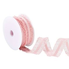 a roll of pink ribbon with white lace