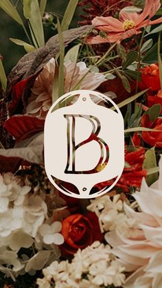 a bouquet of flowers with the letter b on it's centerpiece in white and red