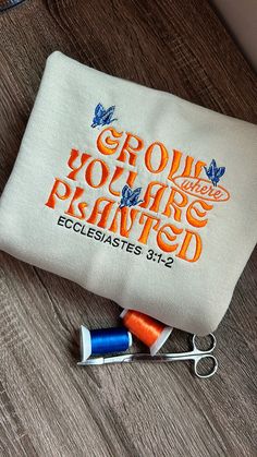 a pair of scissors sitting on top of a table next to a bag with the words grow your own planted