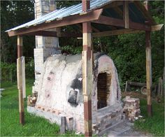 an outdoor pizza oven built into the side of a house