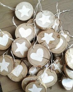 several pieces of wood with white hearts and arrows hanging from the strings on each piece