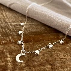 The Silver Tree Sterling Silver Jewellery Silver Moon and Stars Necklace A crescent moon and six silver stars adorn this delicate sterling silver necklace. The moon pendant measures 10mm. The stars measure approx 7mm. Please note this item is handmade to order. Each piece is unique and made just for you so may vary slightly from the photograph. Made using eco-silver. Ethical recycled sterling silver, equal in quality to unrecycled precious metals. Moon And Stars Necklace, Stars Necklace, Silver Tree, Silver Moon, Moon And Stars, Moon Pendant, Recycled Sterling Silver, Star Necklace, Silver Stars