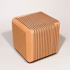 a small wooden block sitting on top of a white surface