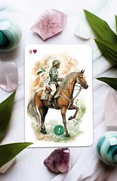 a playing card with an image of a man riding a horse and surrounded by crystals